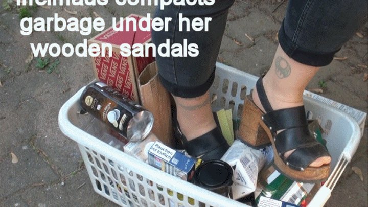 Iffelmaus compacts garbage under her wooden sandals